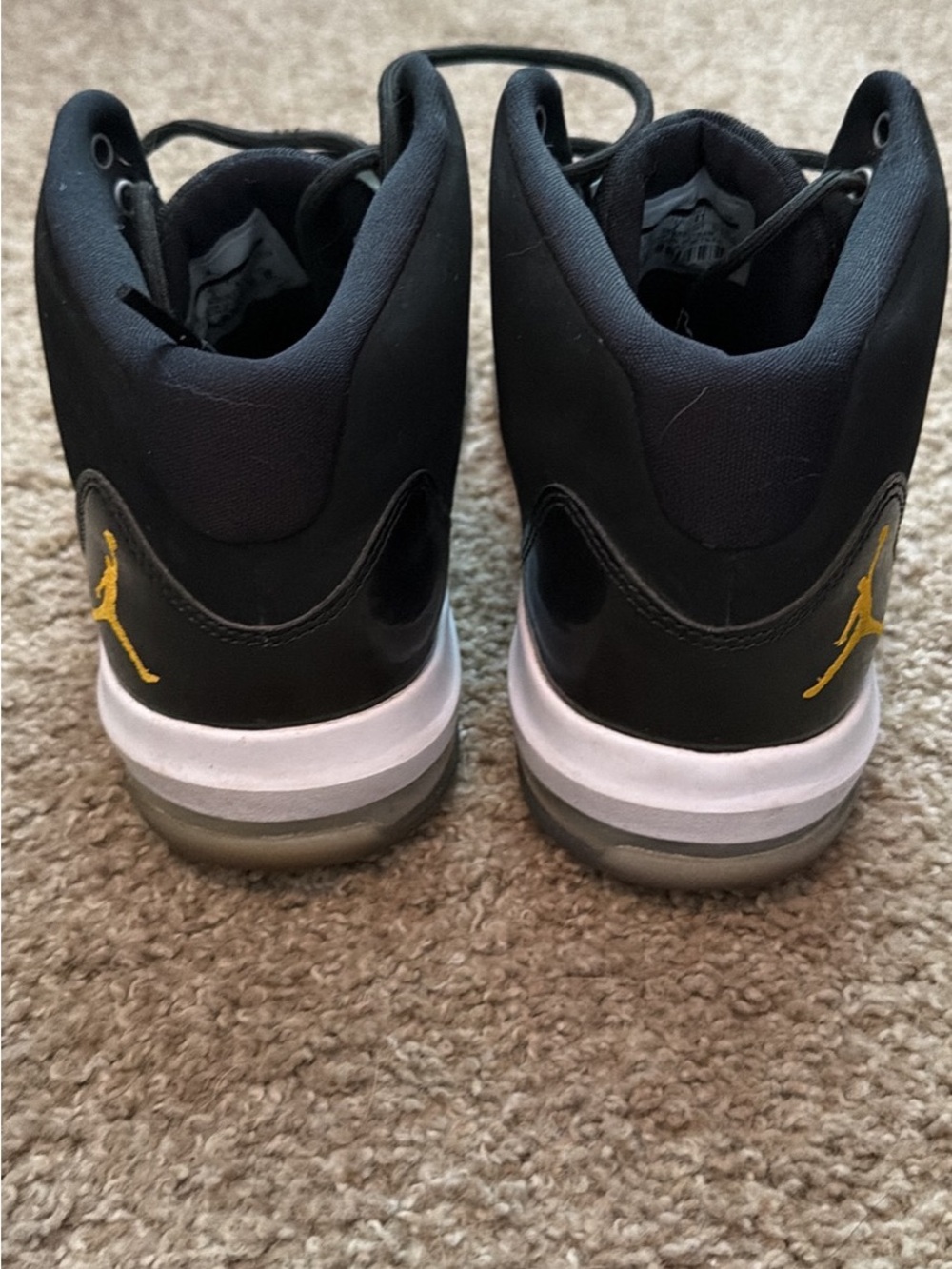 Jordan black sneakers with yellow Jumpman accents